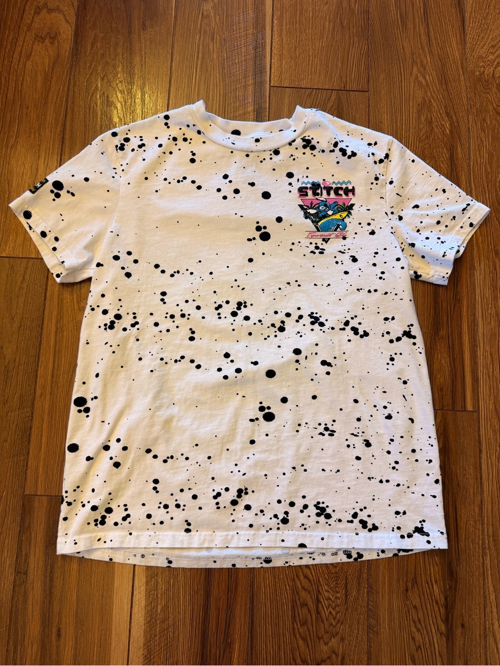 Disney White Tee with Black Paint Splatter and Colorful Stitch Accent